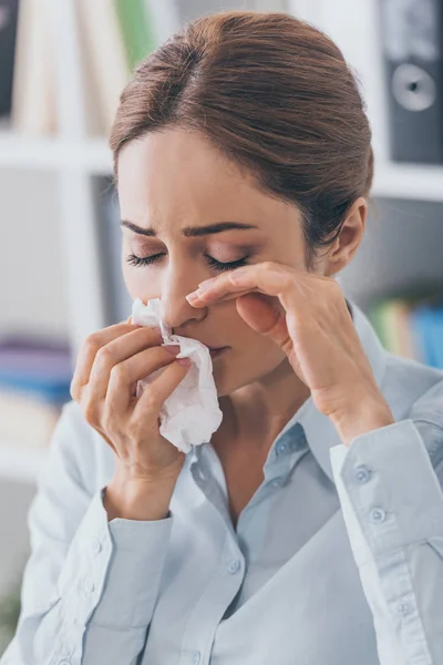 Close-up portrait of crying adult businesswoman with paper napkin at office — Stock Photo