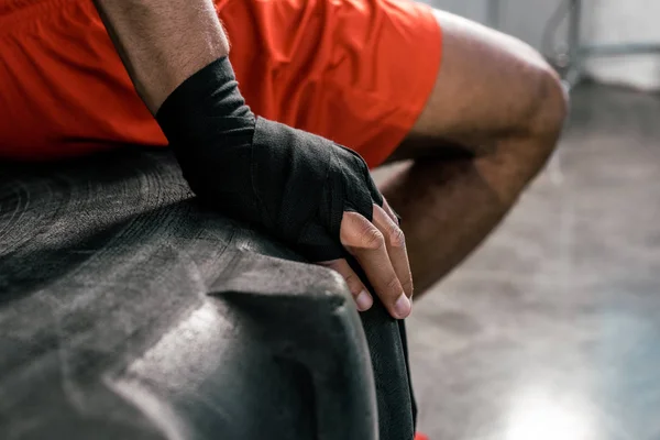 Cropped image of sportsman hand in boxing bandage at gym — Stock Photo