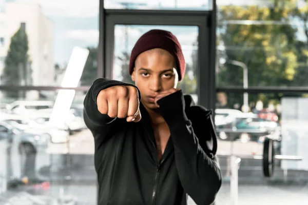 Selective focus of young african american boxer exercising at gym — Stock Photo