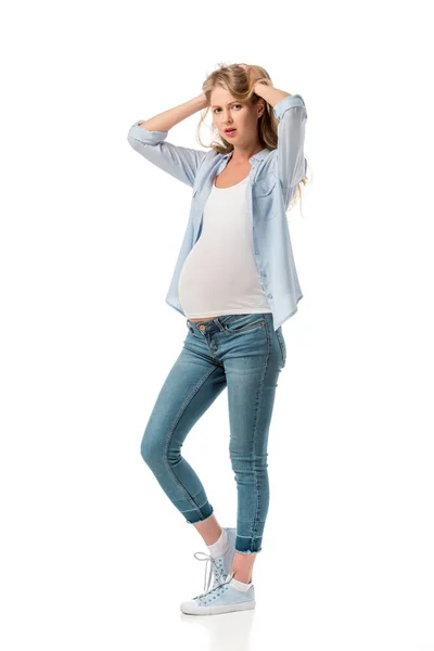 Depressed pregnant woman holding her head and looking at camera isolated on white — Stock Photo