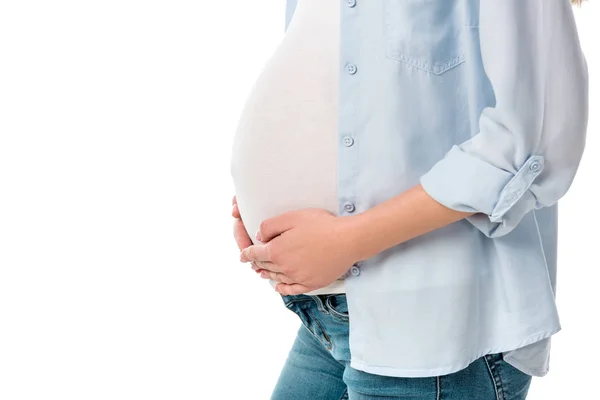 Abgeschnittene Aufnahme einer schwangeren Frau mit Bauch und isolierten Händen auf Weiß — Stockfoto