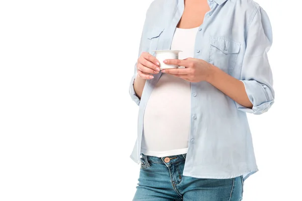 Cropped shot of pregnant woman holding yogurt isolated on white — Stock Photo