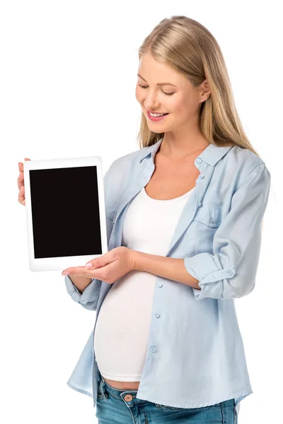 Привлекательная беременная женщина представляет цифровой планшет с чистым экраном, изолированным на белом — стоковое фото