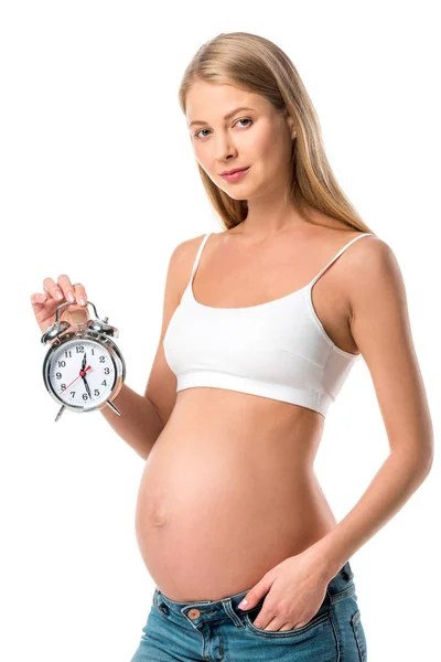 Beautiful pregnant woman holding alarm clock isolated on white — Stock Photo