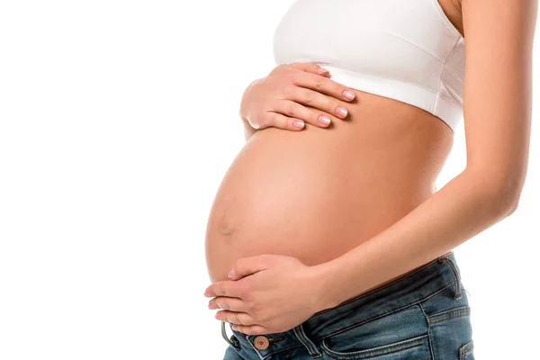 Partial view of pregnant woman touching her belly isolated on white — Stock Photo
