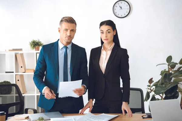 Portrait of business colleagues with papers at workplace in office — Stock Photo