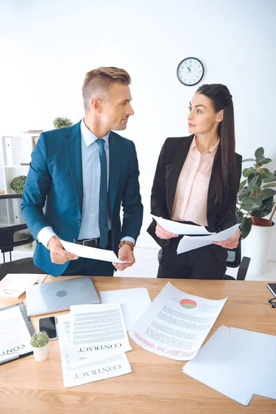 Portrait of business colleagues doing paperwork at workplace in office — Stock Photo