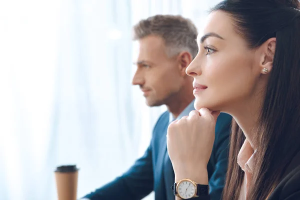 Side view of businesspeople looking away in office — Stock Photo