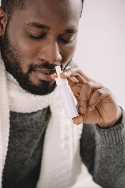 Uomo afroamericano barbuto in calda sciarpa con spray naso — Foto stock