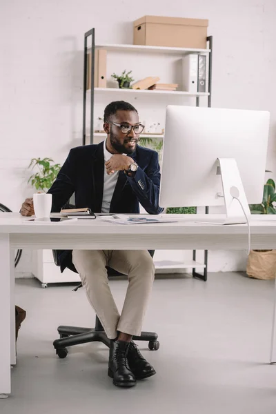 Erfolgreicher afrikanisch-amerikanischer Geschäftsmann arbeitet mit Computer am Arbeitsplatz im modernen Büro — Stockfoto