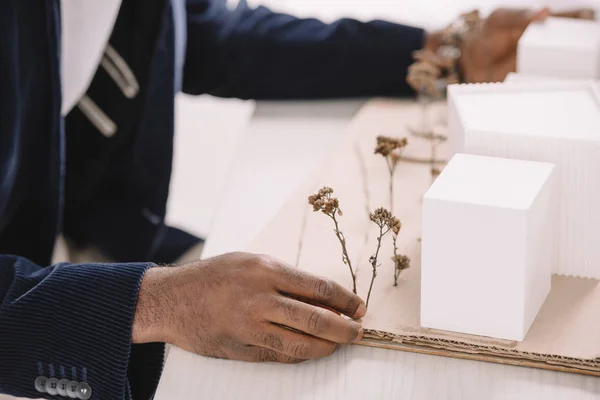 Cropped view of engineer working with business buildings model — Stock Photo