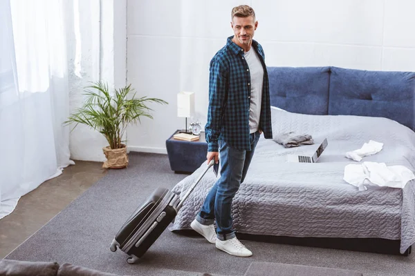 High angle view of adult man carrying travel bag at home — Stock Photo