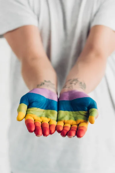 Cropped shot of transgender woman with hands painted in colors of pride flag — Stock Photo
