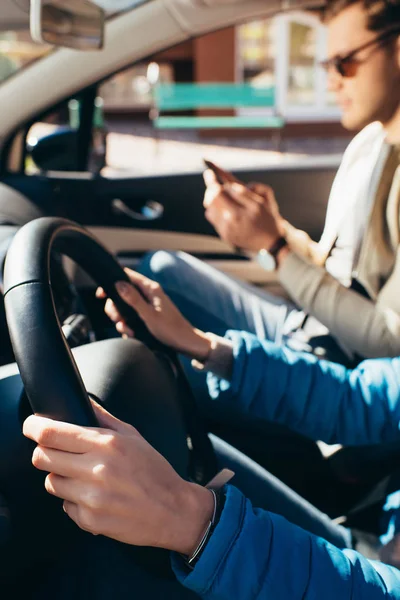 Vista parcial de la mujer conduciendo coche con novio cerca, concepto de viaje - foto de stock