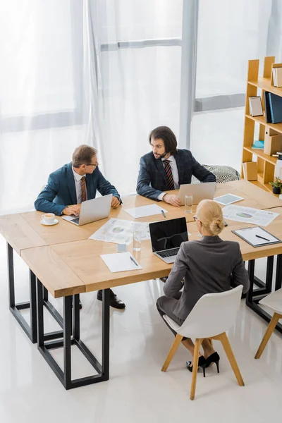 Business people sitting at table and having discussion in office — Stock Photo