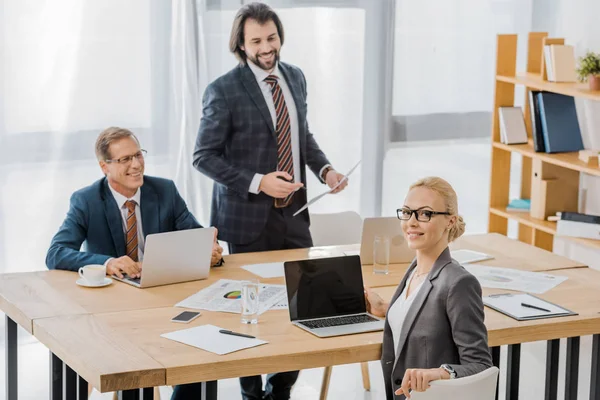 Insurance agents sitting at table at meeting in office — Stock Photo