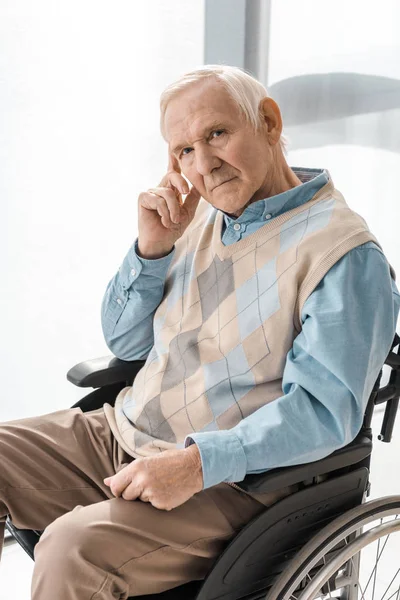 Thoughtful sad senior man sitting in wheelchair in nursing home — Stock Photo