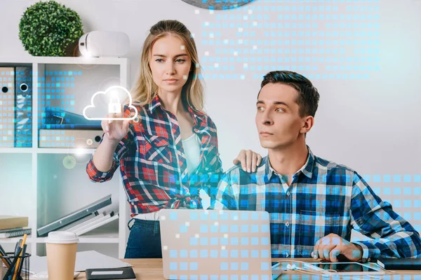 Businessman looking at female colleague pointing at cyber security sign at workplace in office, web security concept — Stock Photo