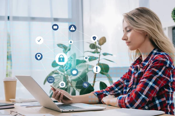 Side view of businesswoman using smartphone at workplace in office, cyber security concept — Stock Photo