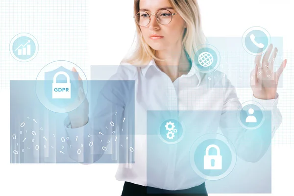 Portrait of concentrated businesswoman in formal wear pointing at cyber security signs isolated on white — Stock Photo