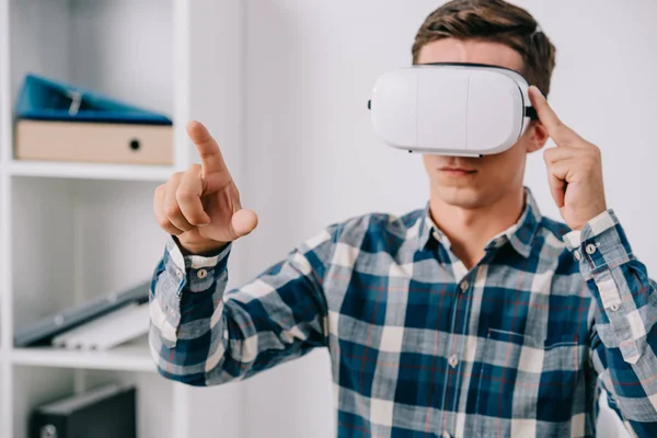 Portrait of man in virtual reality headset gesturing in room — Stock Photo