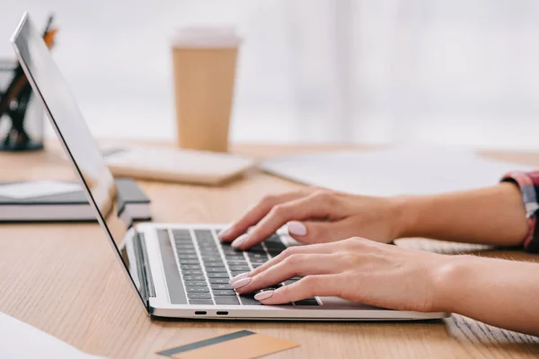 Partial view of businesswoman using laptop while taking part in webinar — Stock Photo