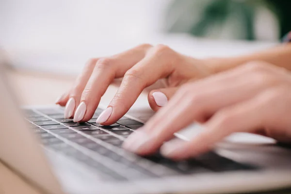 Partial view of eoman typing on laptop — Stock Photo