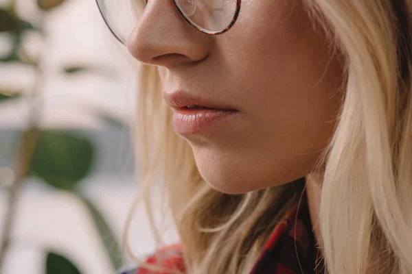 Partial view of blond woman in eyeglasses — Stock Photo