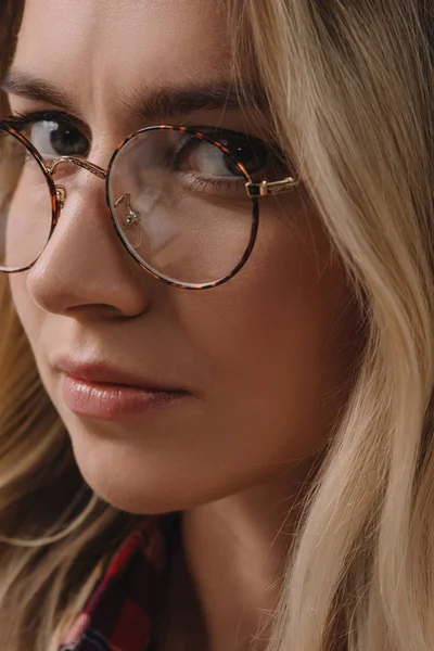 Portrait of beautiful pensive woman in eyeglasses looking at camera — Stock Photo