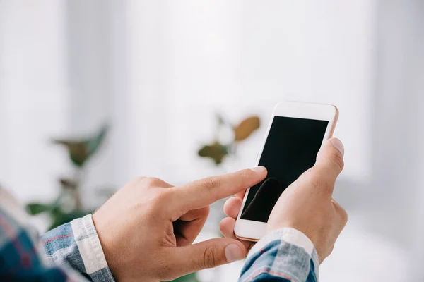 Partial view of man using smartphone with blank screen — Stock Photo