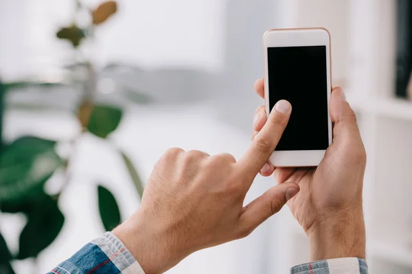 Partial view of man using smartphone with blank screen — Stock Photo