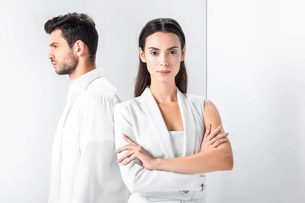 Adult stylish woman in total white standing with arms crossed near man — Stock Photo