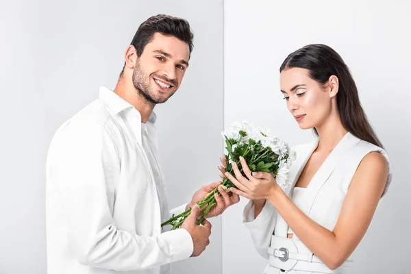 Close up of adult woman gently holding bouquet while happy man smiling — Stock Photo