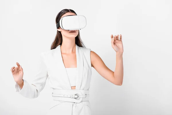 Close up of adult woman gesturing in virtual reality headset isolated on white — Stock Photo