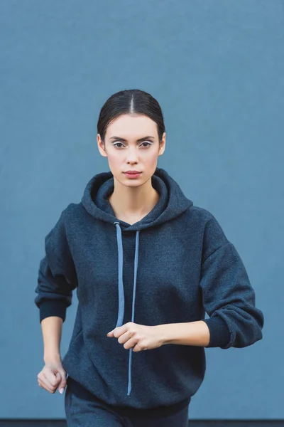 Close up of active adult sportswoman jogging in sportswear — Stock Photo