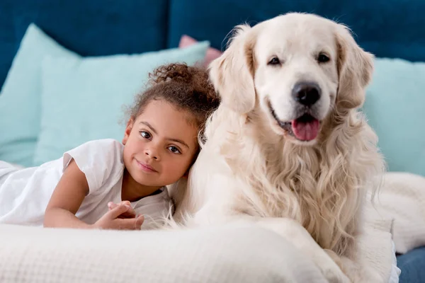 Adorable african american child with happy dog smiling at camera — Stock Photo