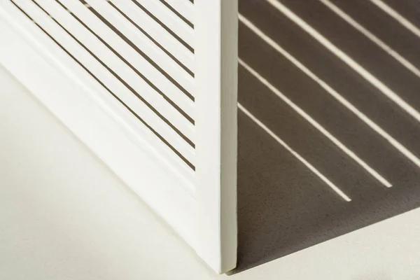 Close up of wooden white room divider against daylight with shadow — Stock Photo