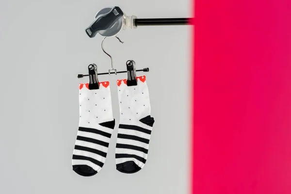 Pair of black and white cotton socks on hanger — Stock Photo