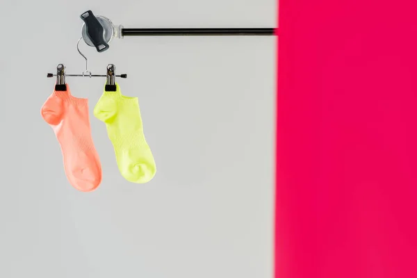 Pair of multicolored socks on hanger with copy space — Stock Photo