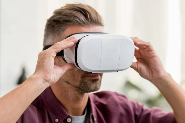 Close up view of man touching virtual reality headset — Stock Photo