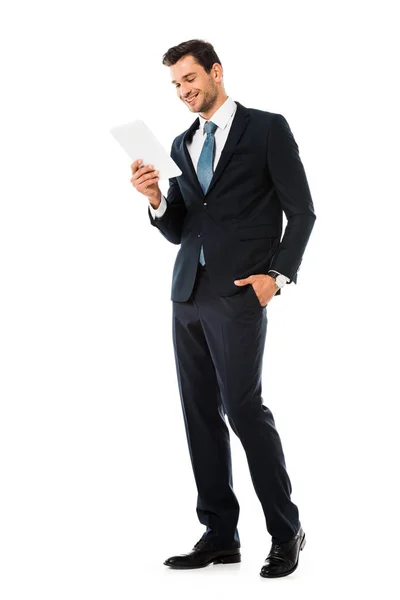 Adult handsome smiling businessman holding digital tablet isolated on white — Stock Photo