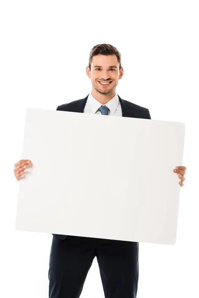 Smiling businessman in suit showing blank poster with copy space isolated on white — Stock Photo