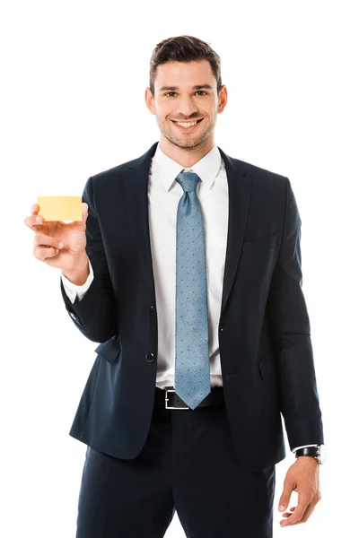 Smiling businessman in suit holding blank business card isolated on white — Stock Photo