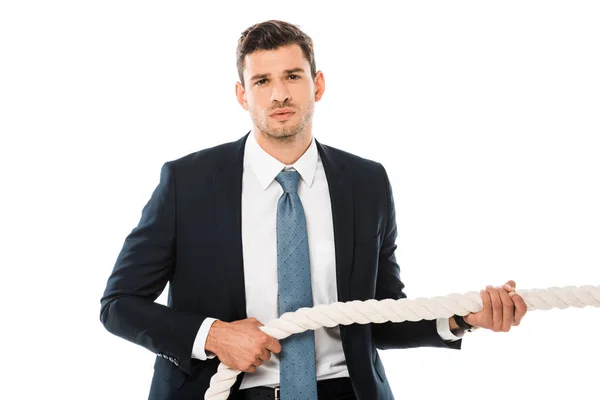 Tense businessman pulling rope and looking at camera isolated on white — Stock Photo