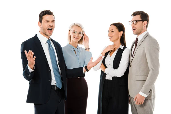 Excitado hombre de negocios de pie con compañeros de trabajo conmocionados aislados en blanco - foto de stock