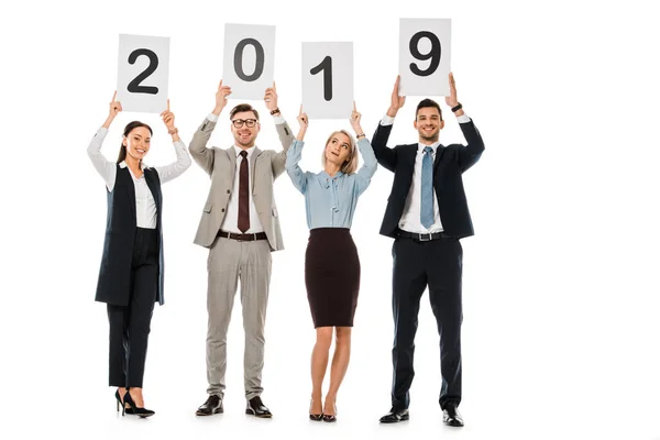 Beautiful businesspeople holding cards with 2019 new year sign isolated on white — Stock Photo
