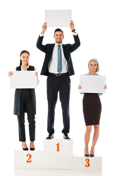 Businesspeople holding blank placards while standing on winners podium isolated on white — Stock Photo