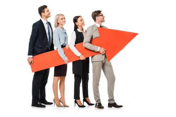 Young smiling businesspeople holding big red arrow together isolated on white — Stock Photo