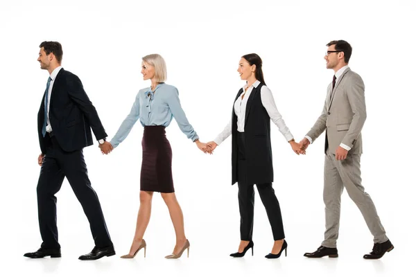 Confident businesspeople holding hands and walking ahead isolated on white — Stock Photo