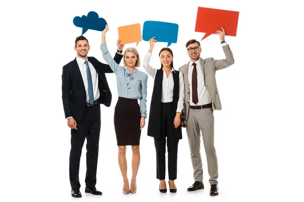 Group of businesspeople holding colorful speech bubbles isolated on white — Stock Photo